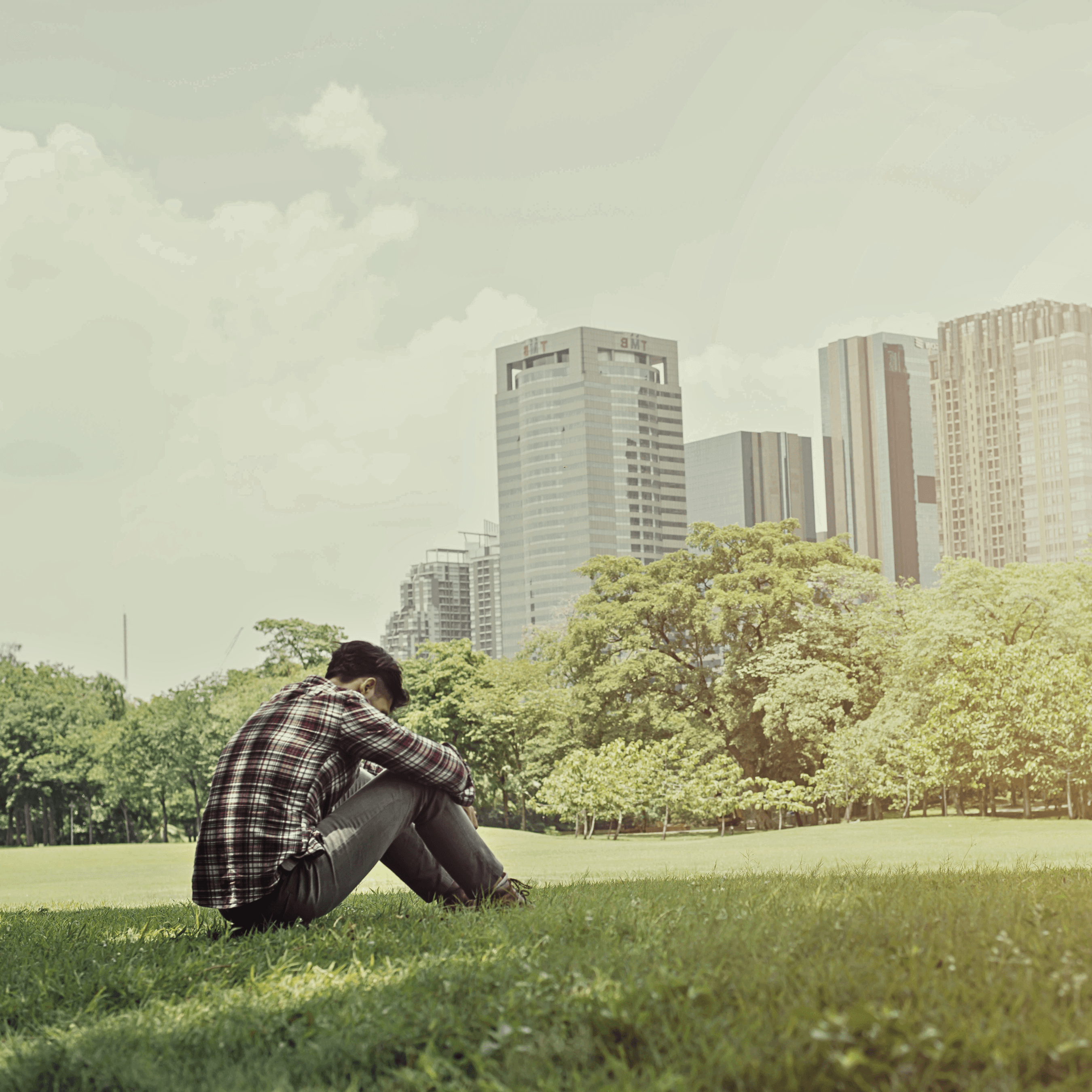 A man sitting in a park in Singapore.