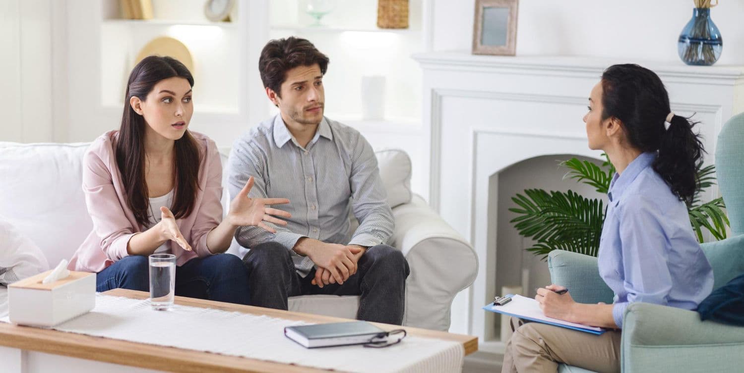 A young couple engaged in a divorce counselling session in Singapore.