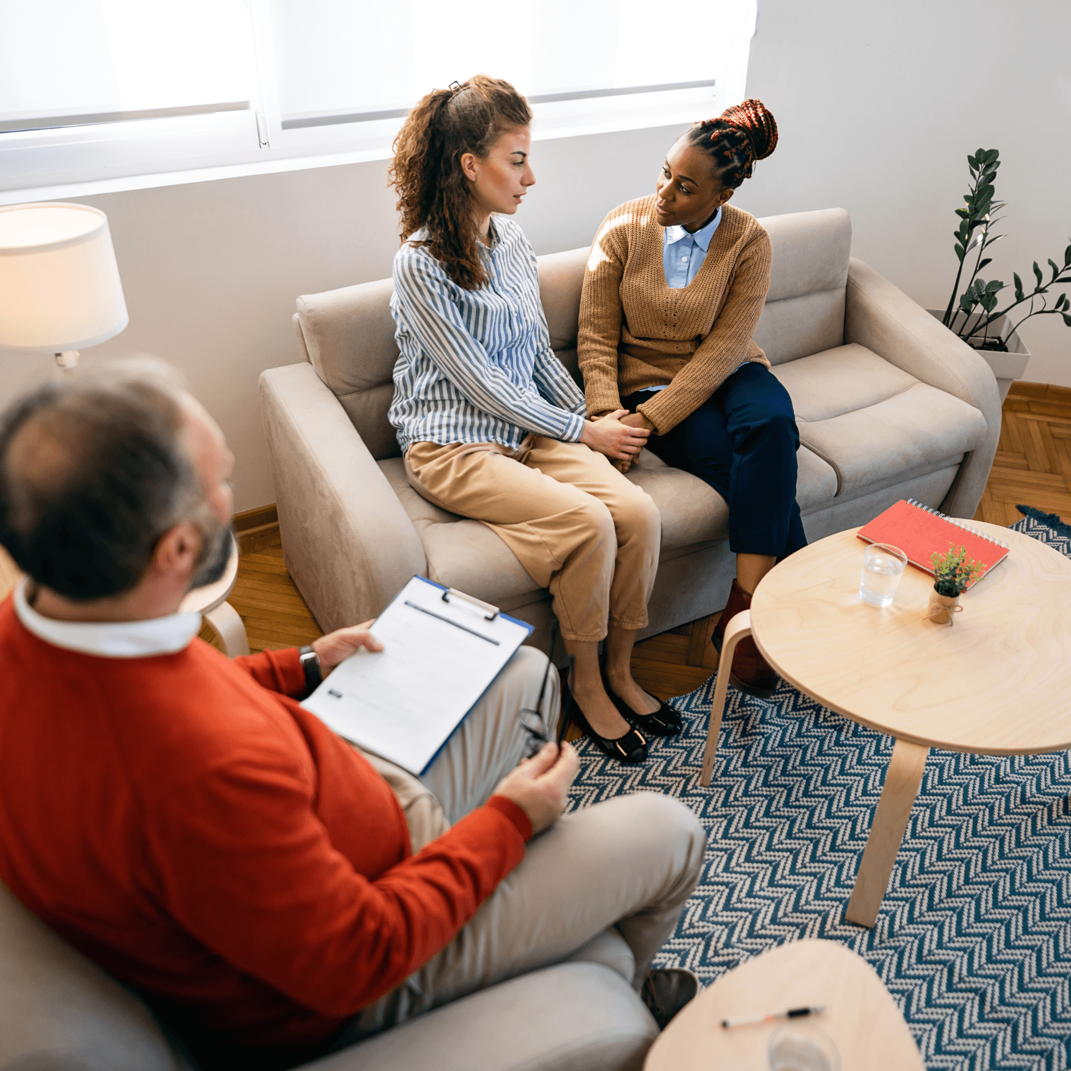 Queer couple seeking therapy with a mental health therapist.