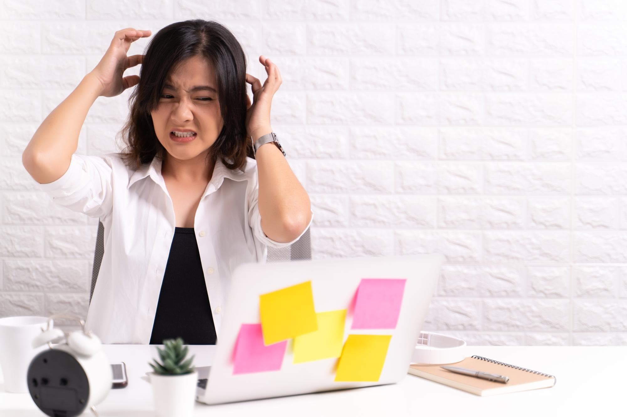 A person sitting at the desk and feeling angry.