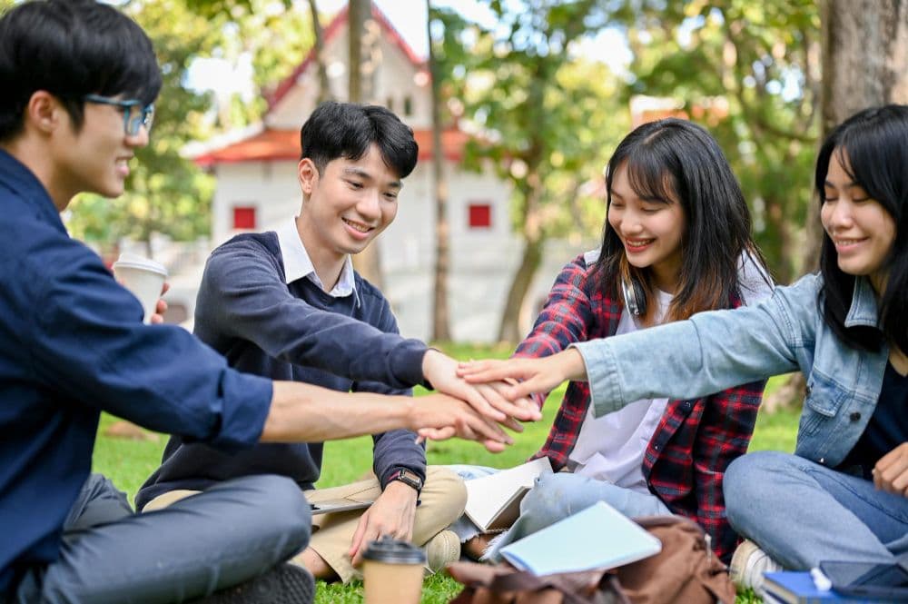 A group of young adults in Singapore reading mental health quotes together.