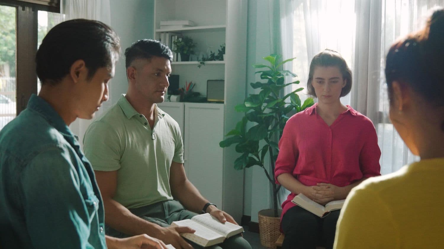 Four people sitting in a room and discussing about personalised therapy approach