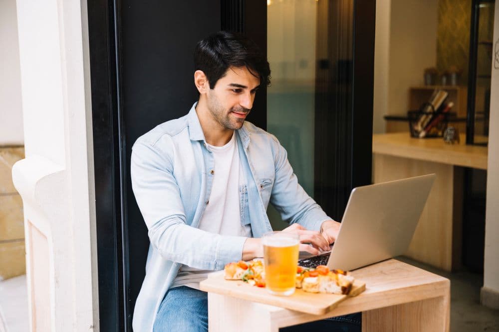 A person joining an online counselling session from a private and cosy cafe.