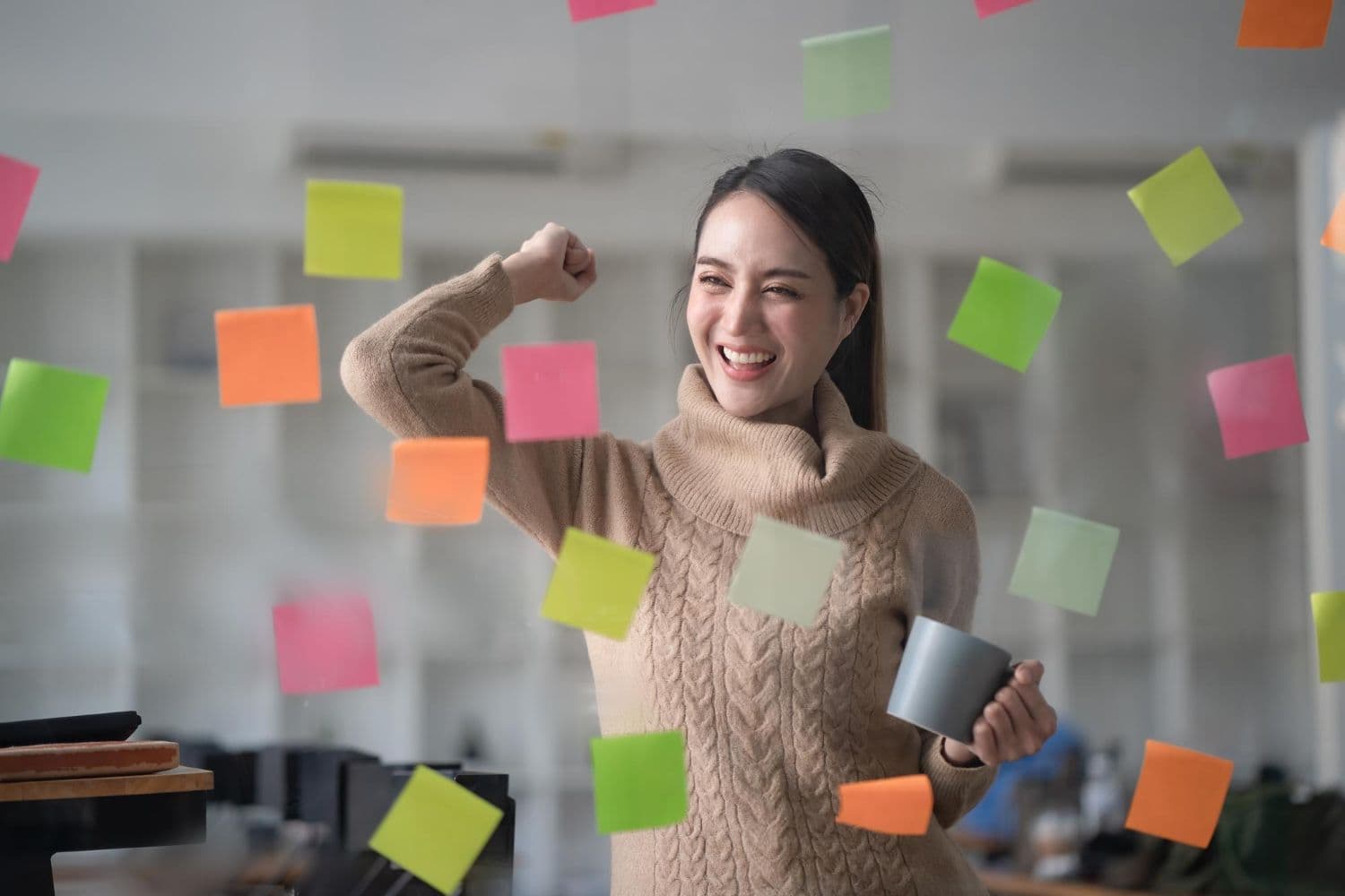 A person celebrating progress made towards reaching their life goals after therapy for personal growth.