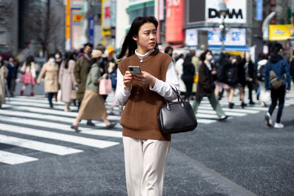 A person standing in alone in a crowded road wondering "Why am I judgmental"?