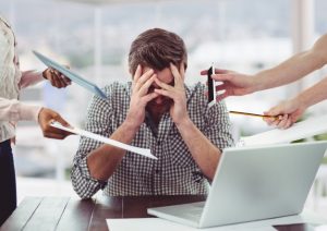 An employee experiencing stress related to work due to multiple demands