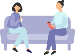 An image of two women sitting on a couch, facing each other. Psychologists in Singapore use therapy to help their clients work through the emotional challenges they are facing and create long-lasting change.