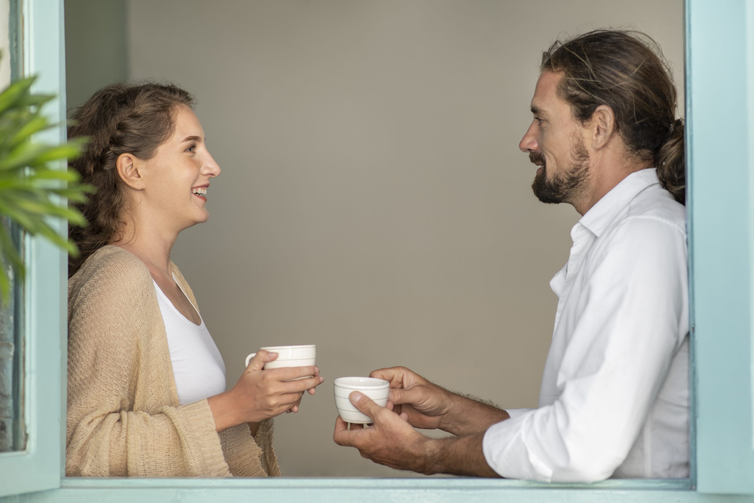 Couple drinking coffee and talking to each other to build a healthy relationship.