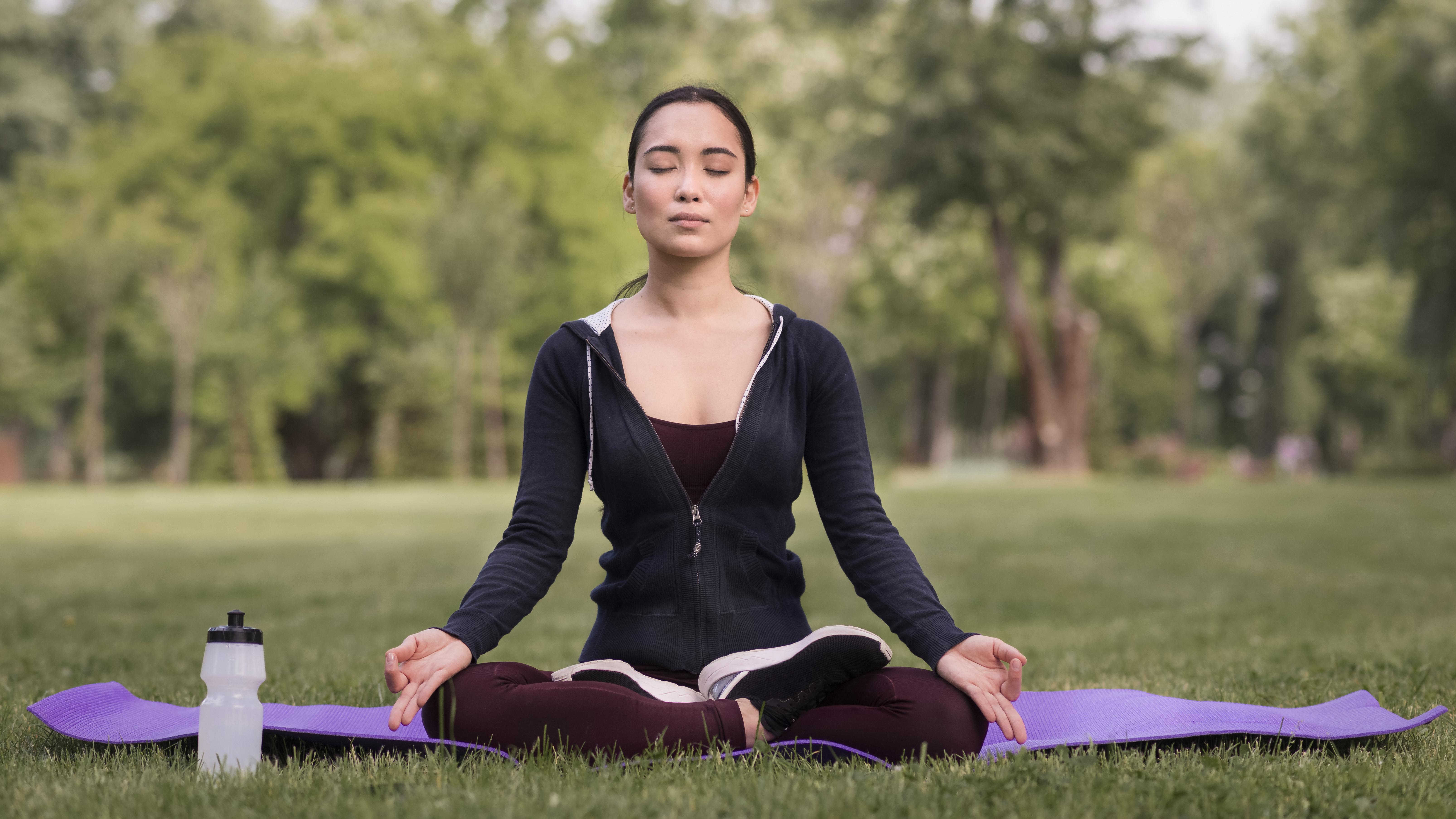 Person engaging in breathing exercises to control anxiety syndrome