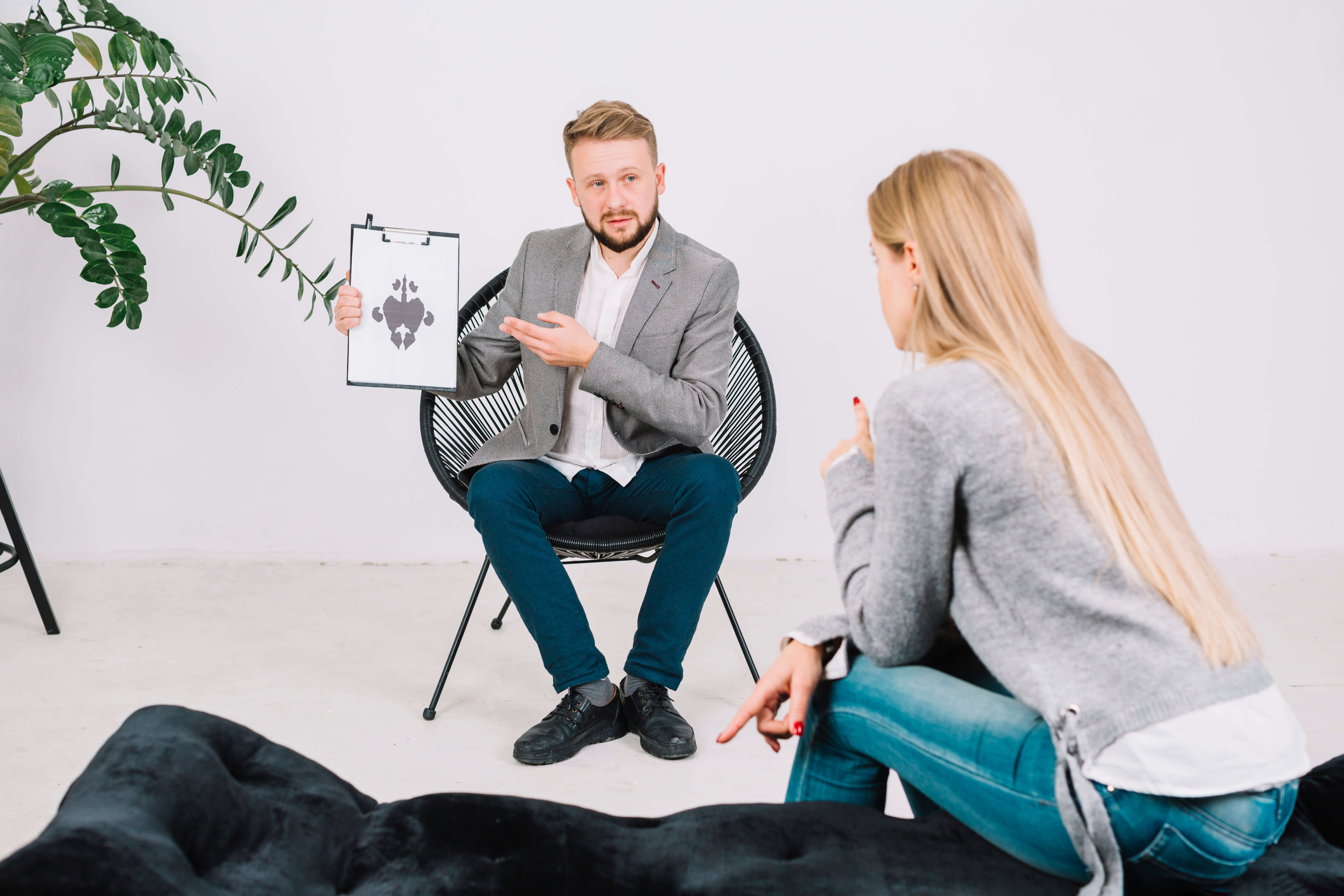 Psychologist showing Rorschach test card to a client with panic attacks