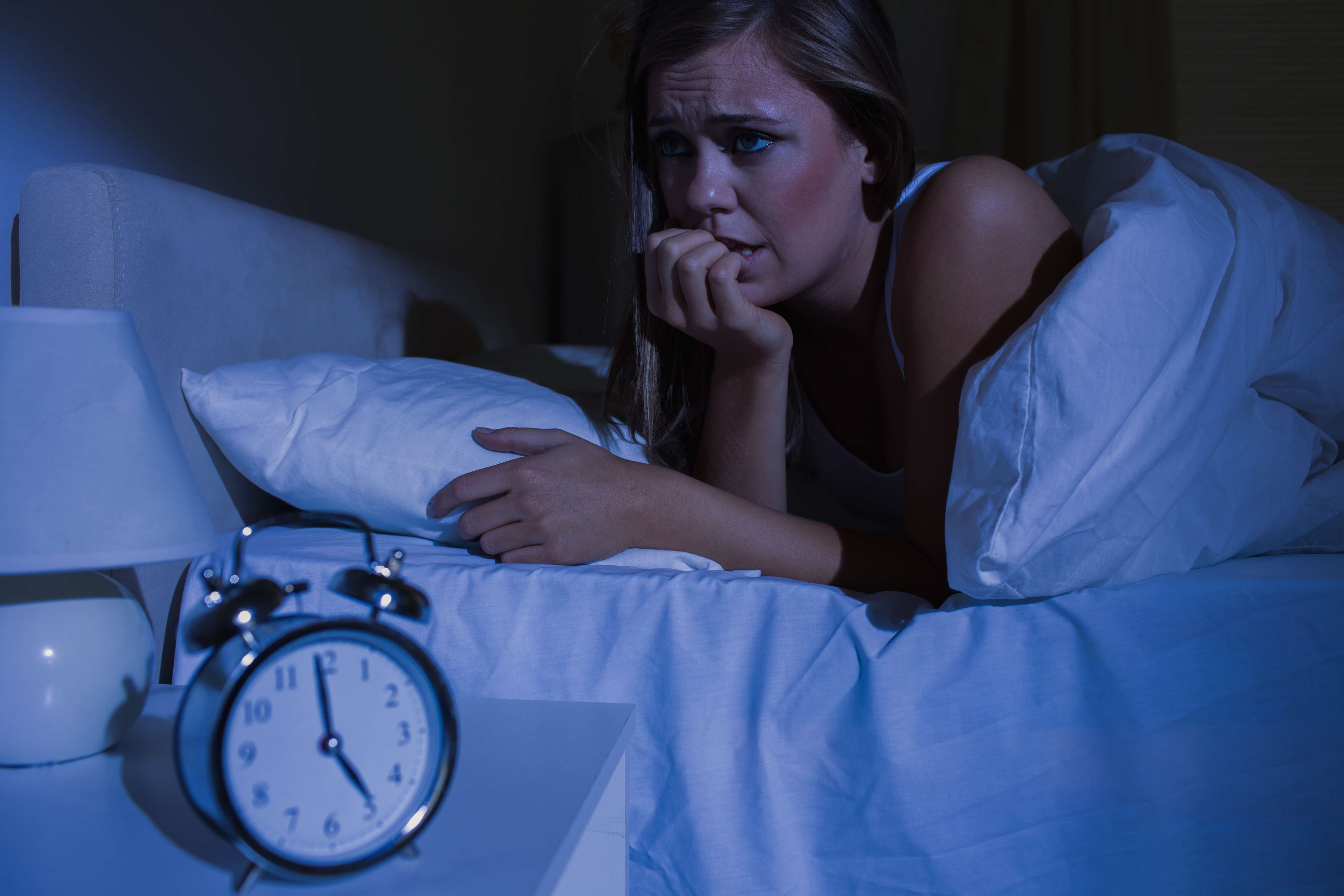 Person struggling to sleep due to symptoms of depression.