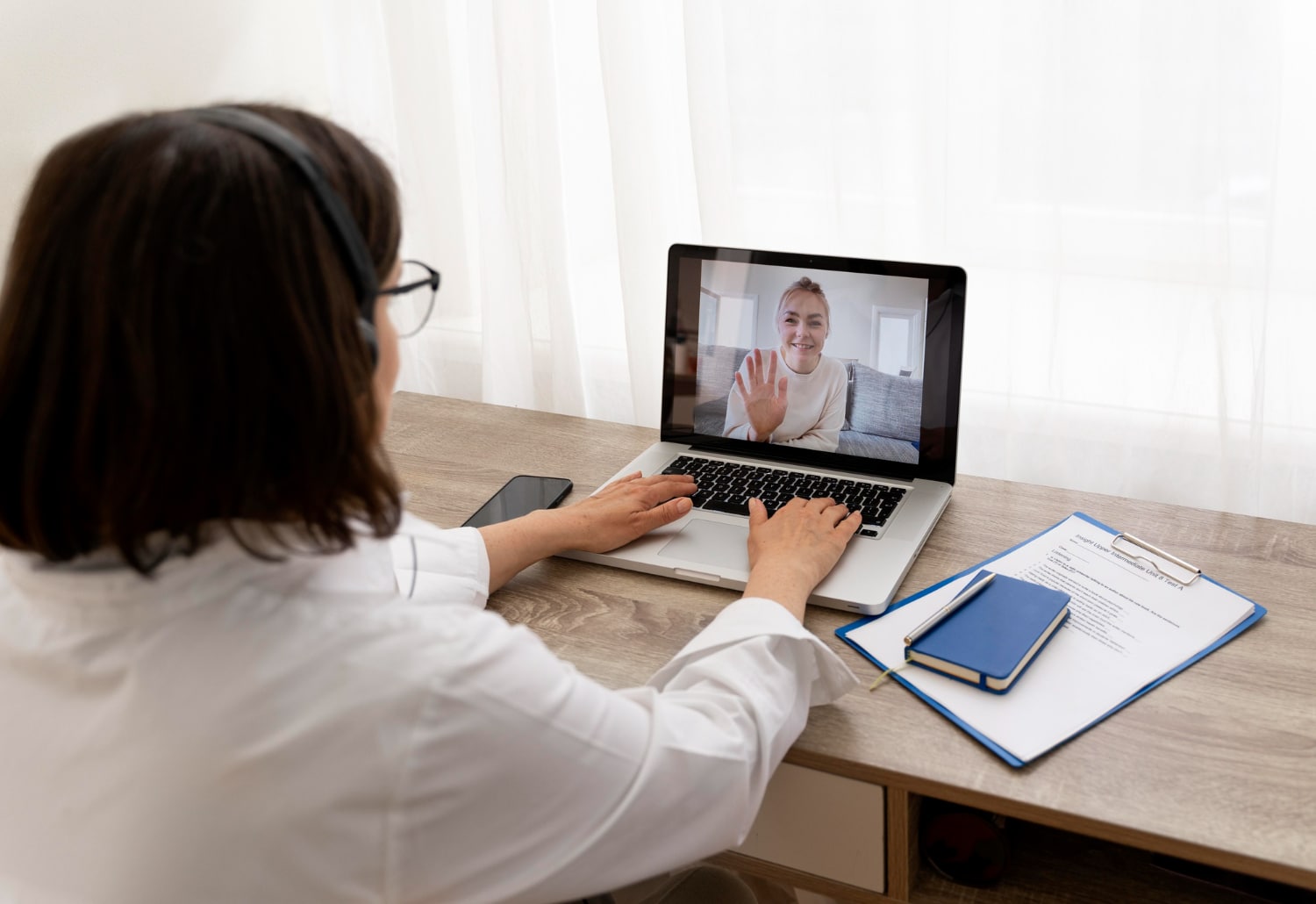 A client talking to an online therapist via video call.