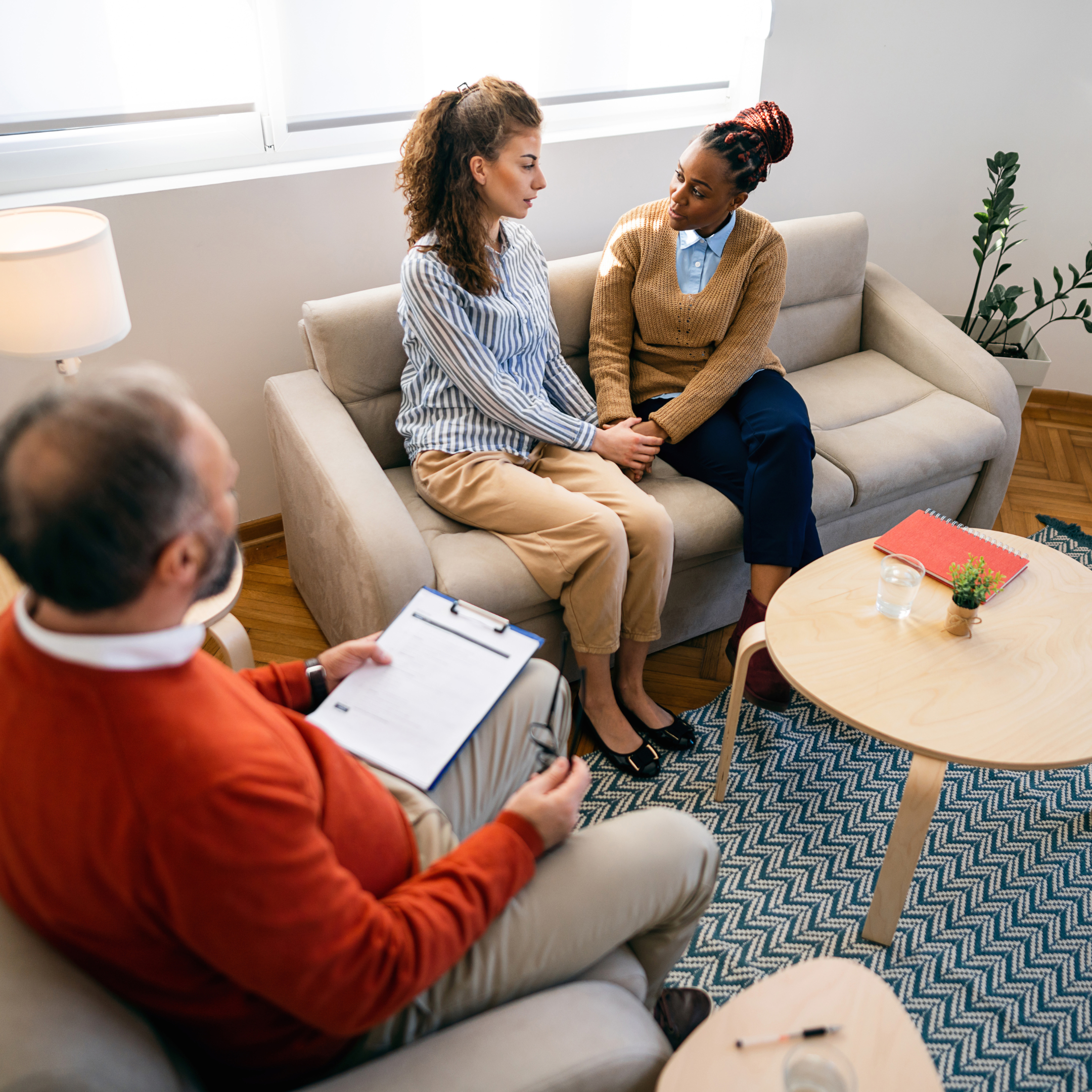 Queer couple seeking therapy with a mental health therapist.