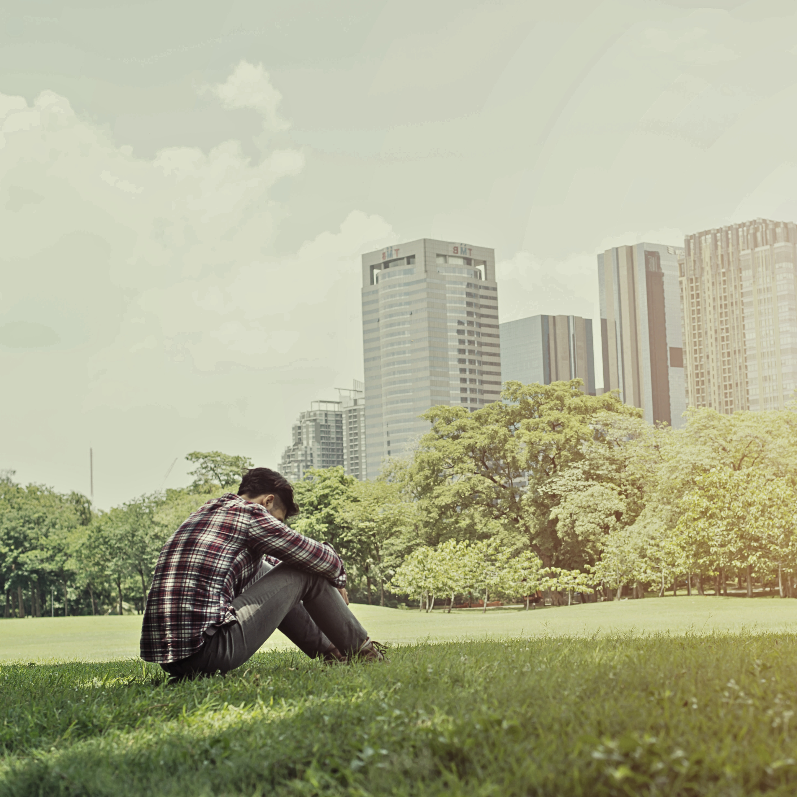 A man sitting in a park in Singapore.