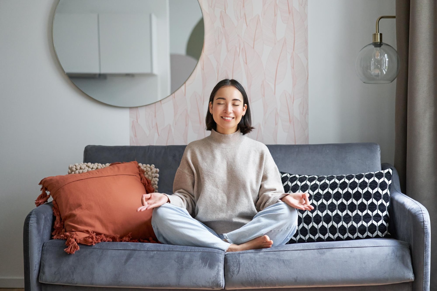 Person meditating on a couch, reflecting relaxation and mindfulness in a therapist session.