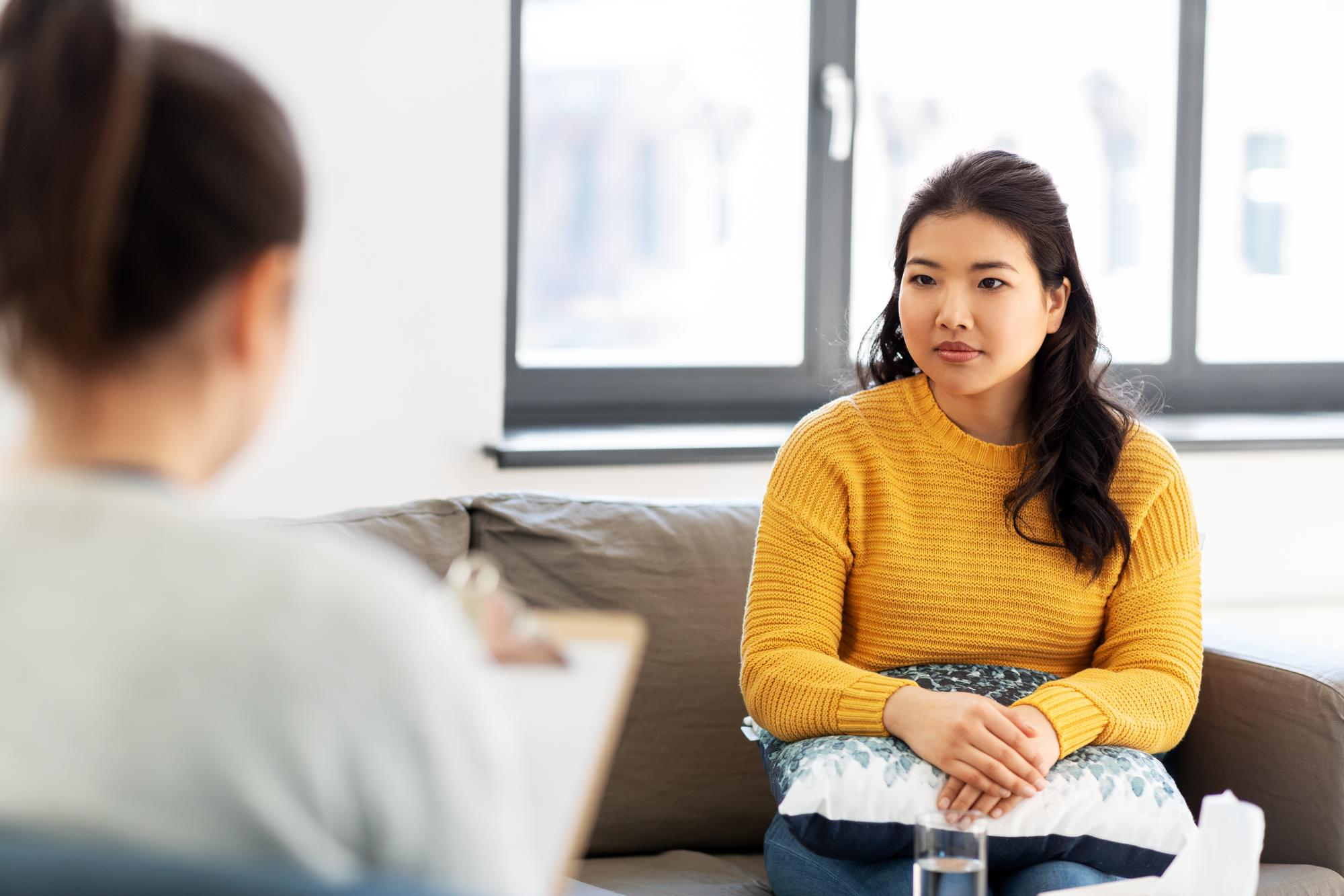 A client talking to a therapist during therapy services.