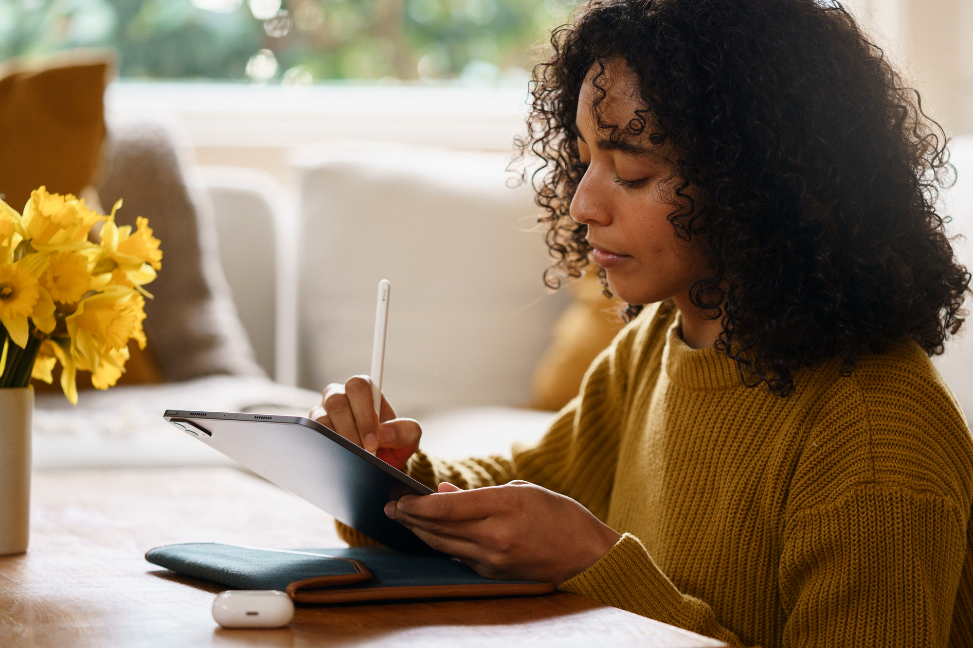 A person journaling on their tablet after an online therapy session