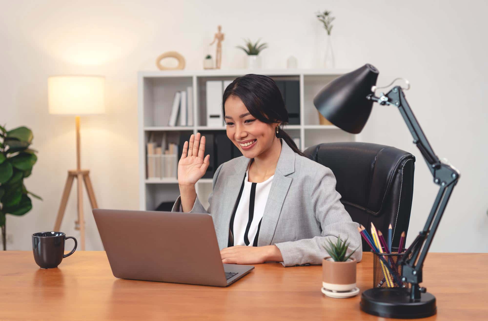 A therapist in Singapore welcoming a client to an online therapy session on video call.