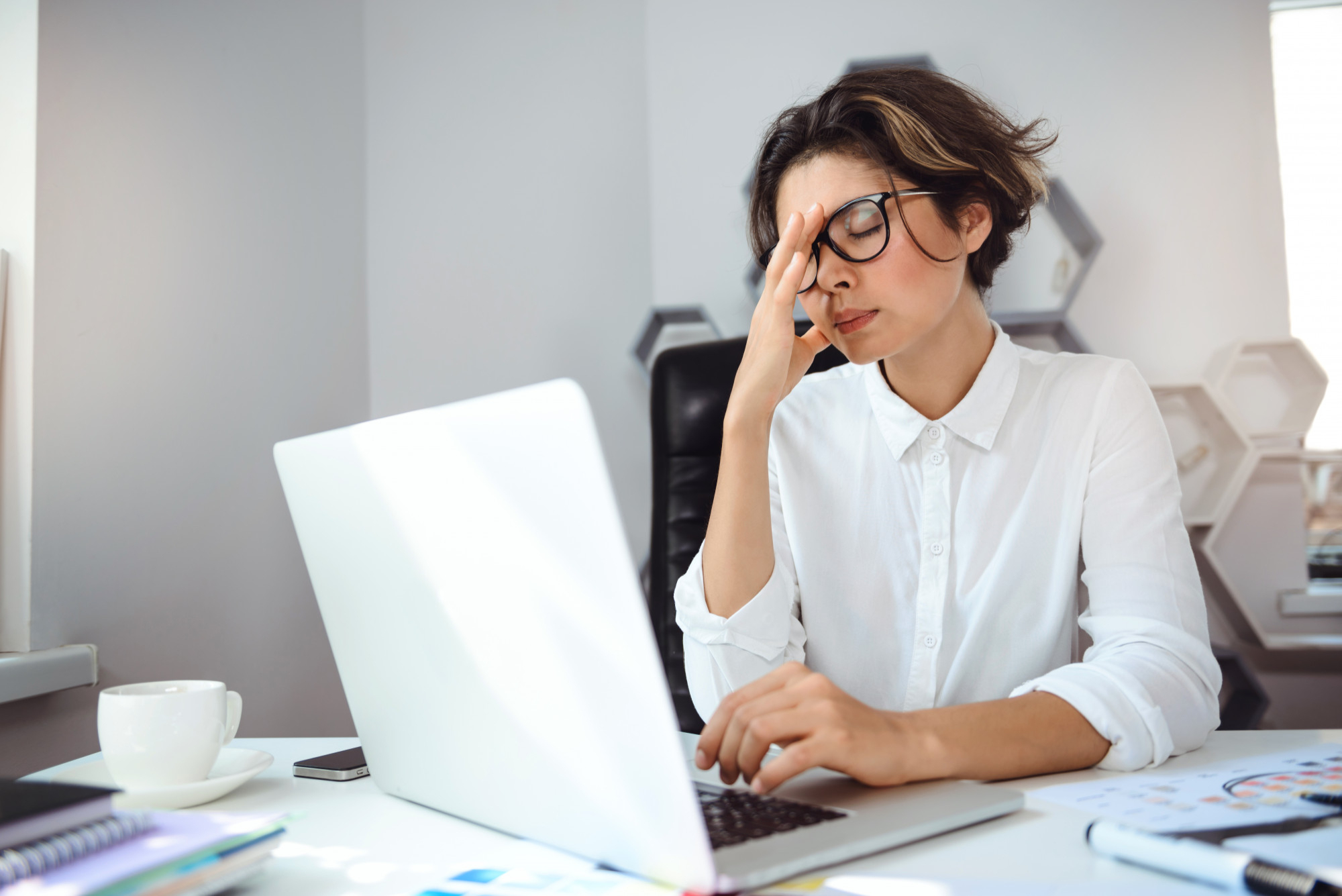 A person at work, looking visibly stressed and confused.