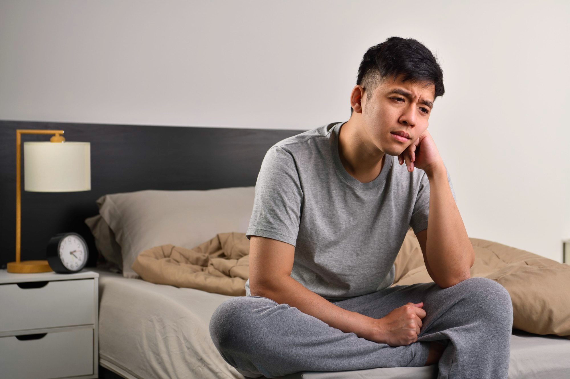 A man considering seeking therapy in Singapore.