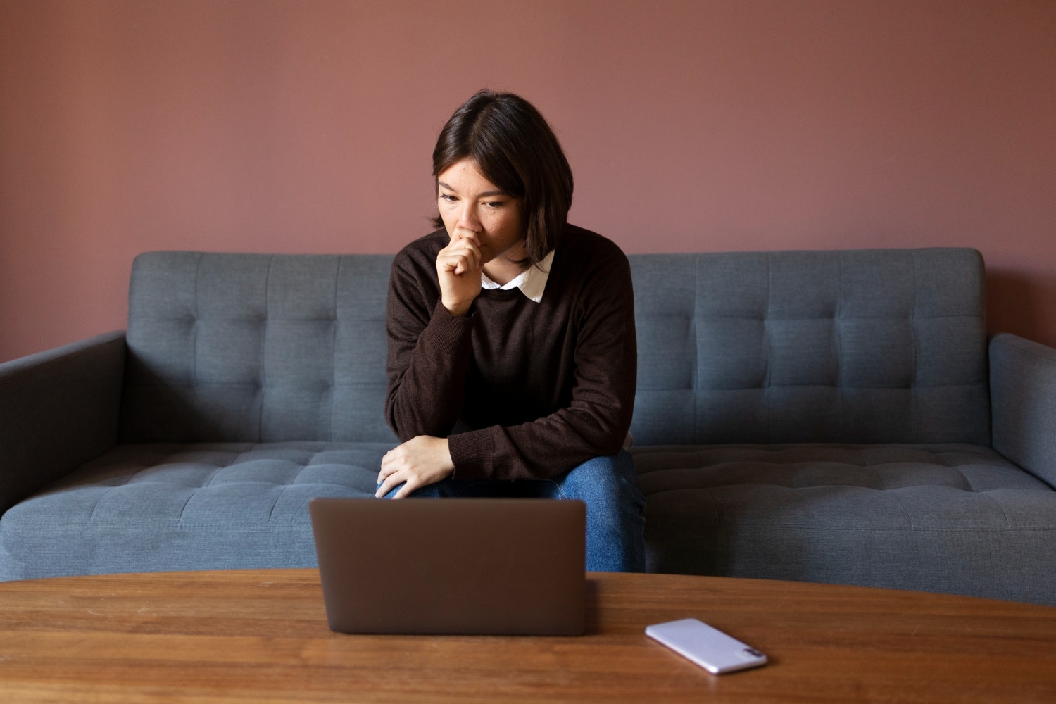 A person on the couch thinking about switching therapists in Singapore.